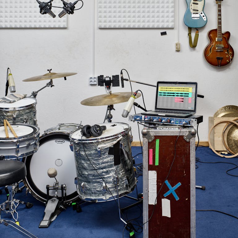 Live 12 Lite on a laptop, rehearsal space with drum kit